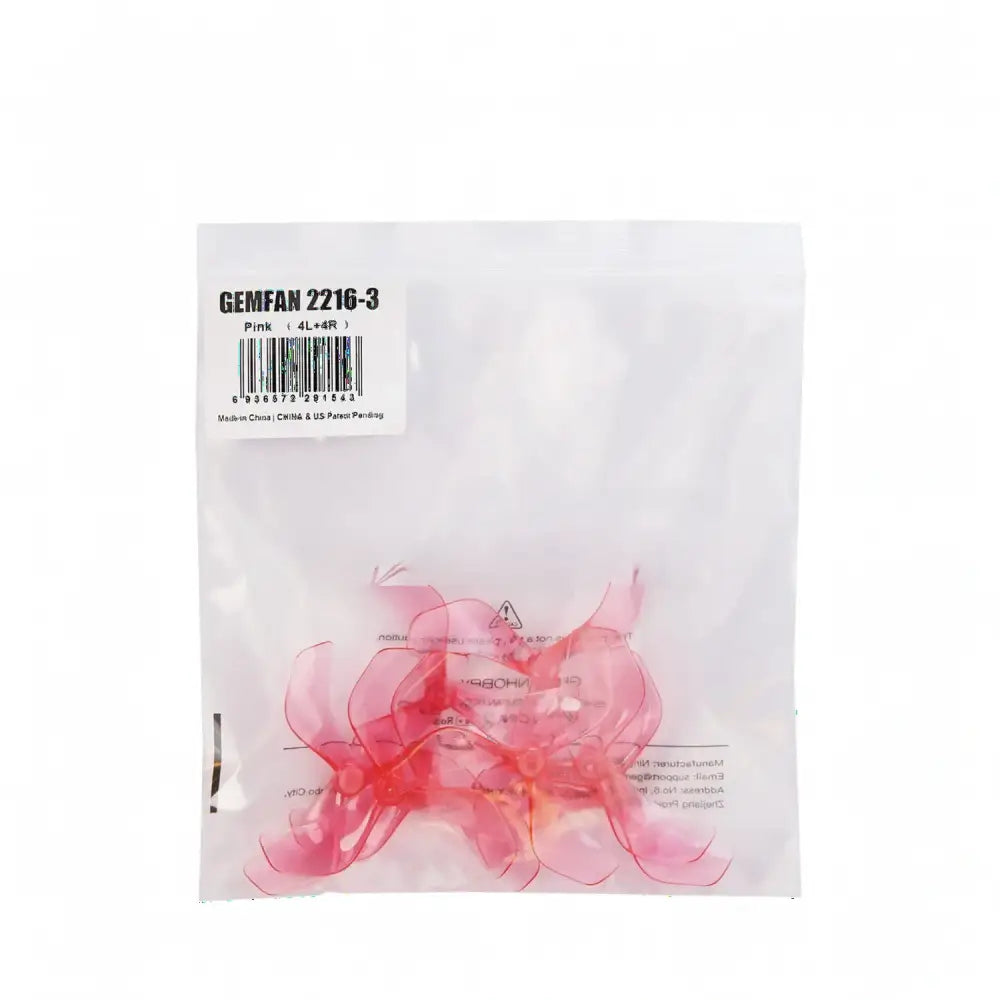 Hélice Gemfan 2216-3 rose translucide à 3 pales pour drones de course FPV, emballée.